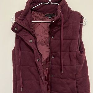 Maroon vest, thick material, has both buttons & a zipper. Women’s size S-M.